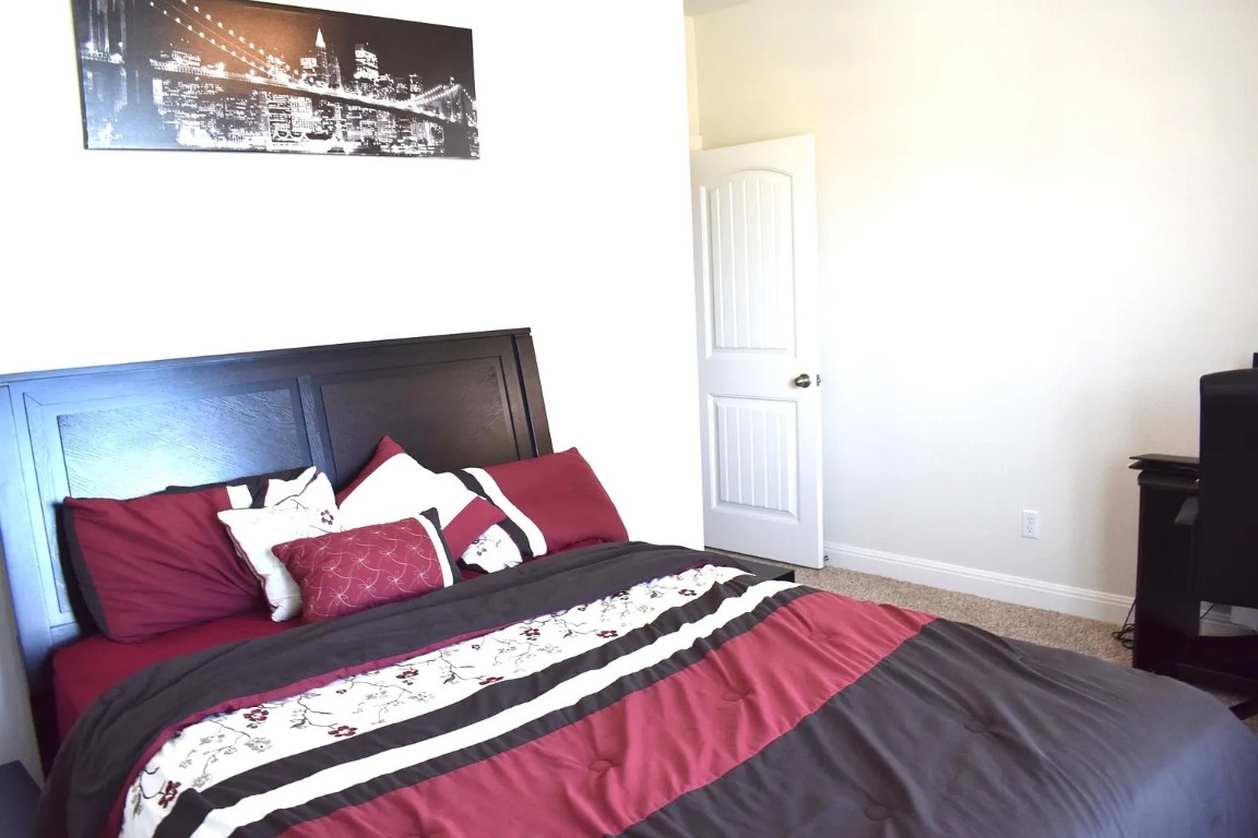 1109 Sundrops Street Leander, TX 78641 - Photo 35 of 40 a bedroom with a bed and a flat screen tv