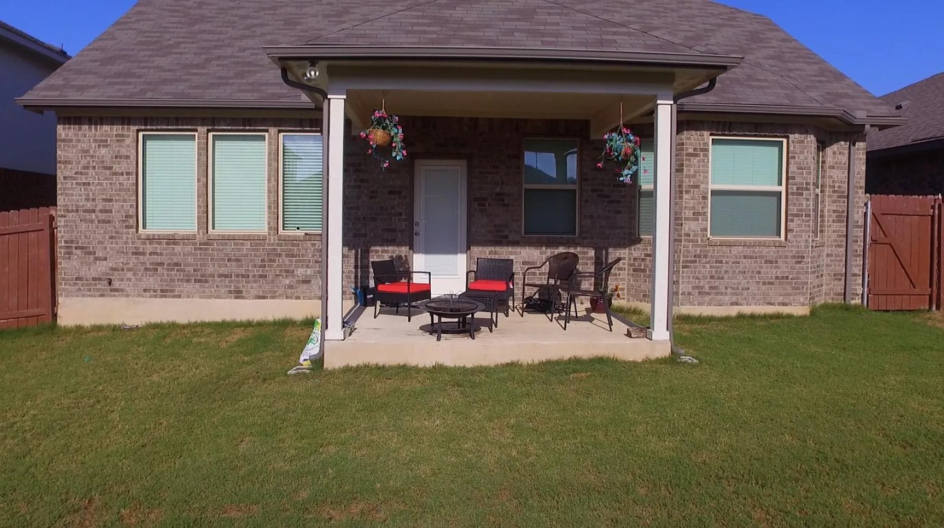 1109 Sundrops Street Leander, TX 78641 - Photo 38 of 40 a view of a patio with table and chairs and potted plants
