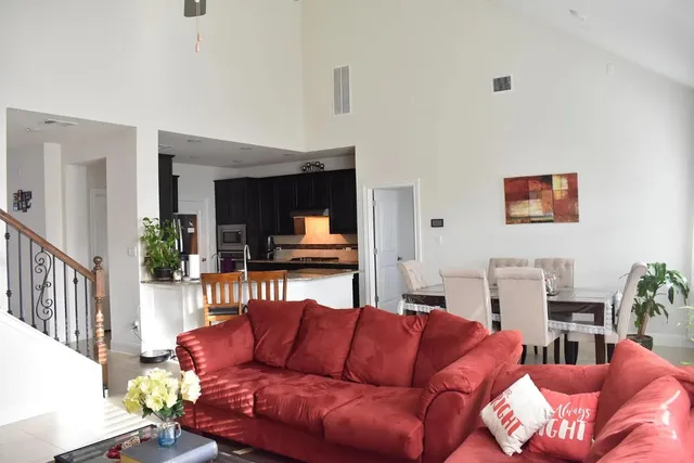 a living room with furniture a flat screen tv and a couch