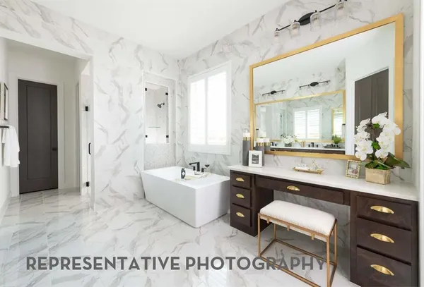 a spacious bathroom with a tub sink and mirror
