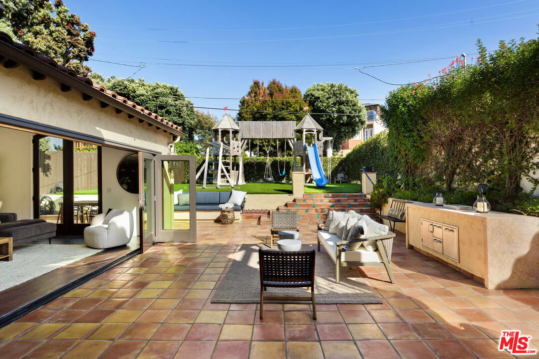 254 Rees Street Playa del Rey, CA 90293 - Photo 29 of 32 a view of a patio with couches table and chairs with potted plants and large trees