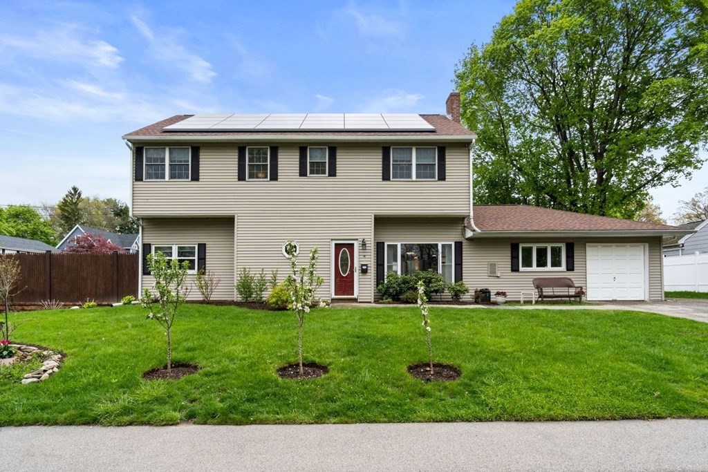a front view of a house with a yard and porch
