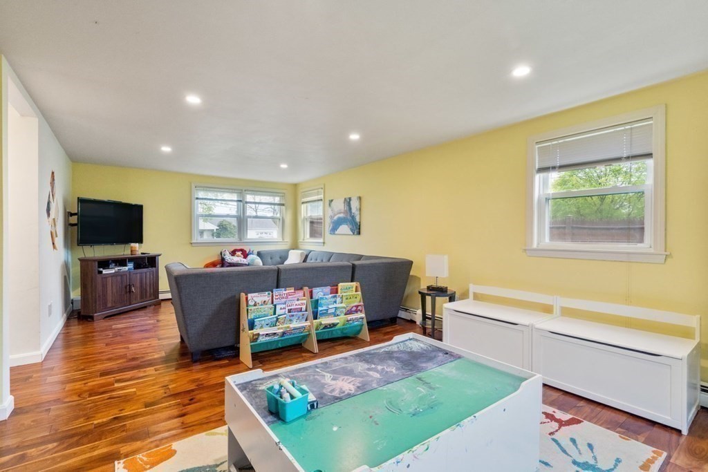 14 Rutledge Road Natick, MA 01760 - Photo 13 of 39 a living room with furniture a flat screen tv and a dining table
