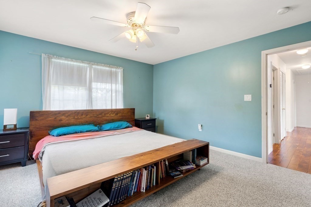 14 Rutledge Road Natick, MA 01760 - Photo 17 of 39 a bedroom with a bed a chandelier and a chair