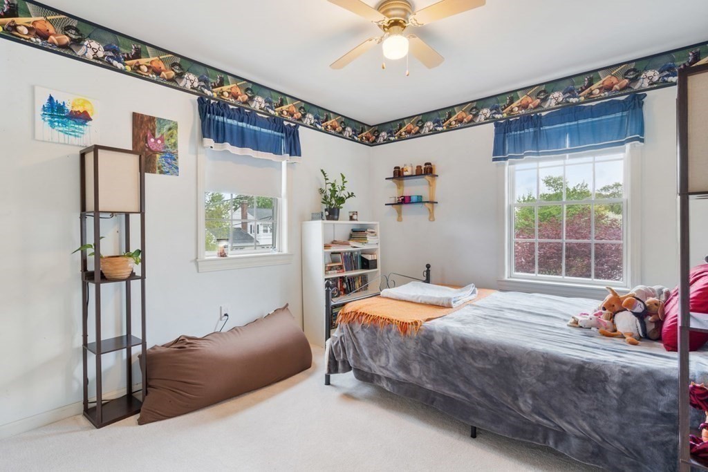 14 Rutledge Road Natick, MA 01760 - Photo 25 of 39 a bedroom with a bed and a chandelier