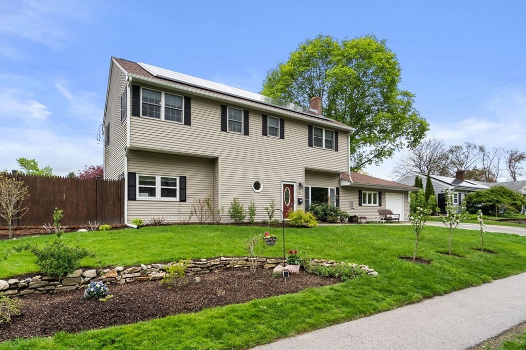 14 Rutledge Road Natick, MA 01760 - Photo 3 of 39 a front view of a house with a garden and trees