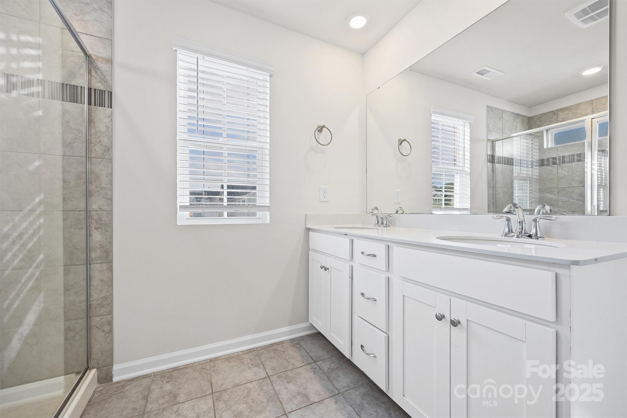 5038 Moss Pne Way Fort Mill, SC 29708 - Photo 15 of 25 a bathroom with a double vanity sink a mirror and a shower