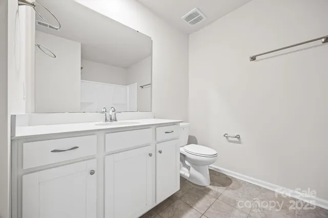 a bathroom with a sink toilet and a mirror