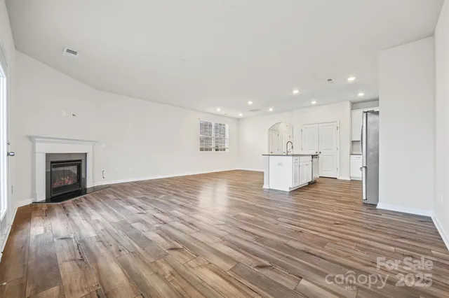 a view of kitchen and hall with wooden floor