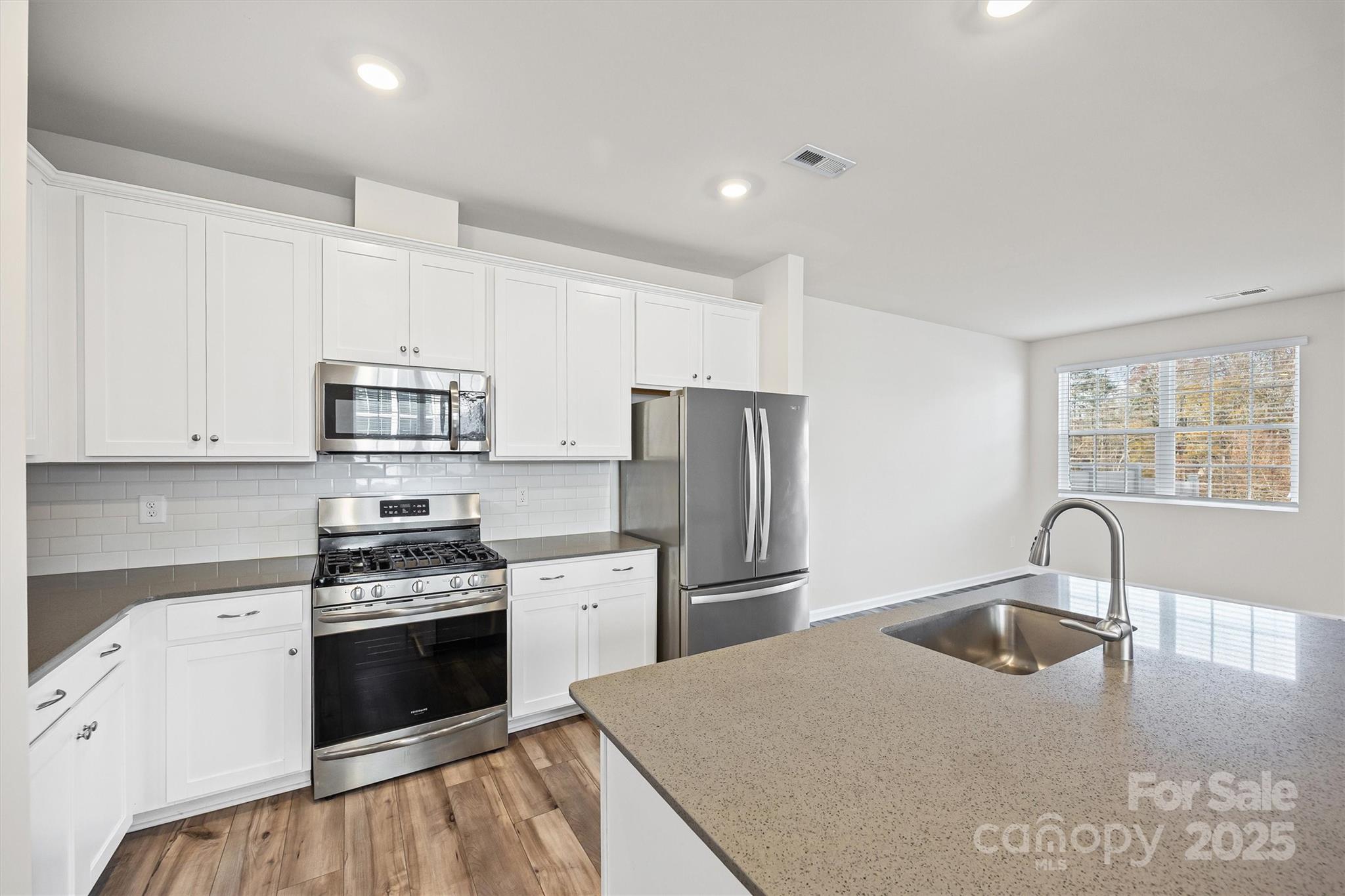 5038 Moss Pne Way Fort Mill, SC 29708 - Photo 9 of 25 a kitchen with stainless steel appliances granite countertop a sink stove and refrigerator