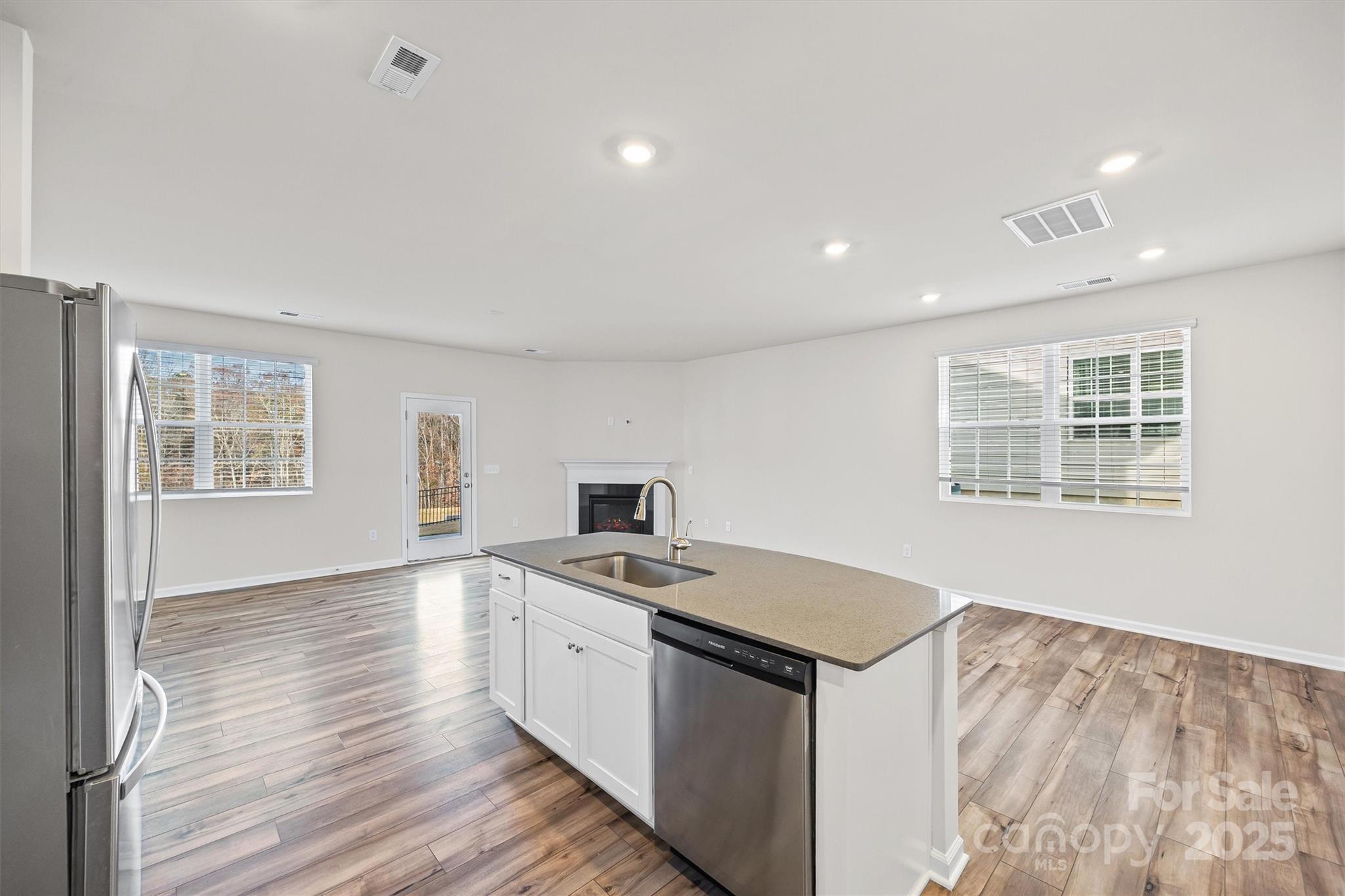 5038 Moss Pne Way Fort Mill, SC 29708 - Photo 10 of 25 a kitchen that has a sink in it and wooden floors