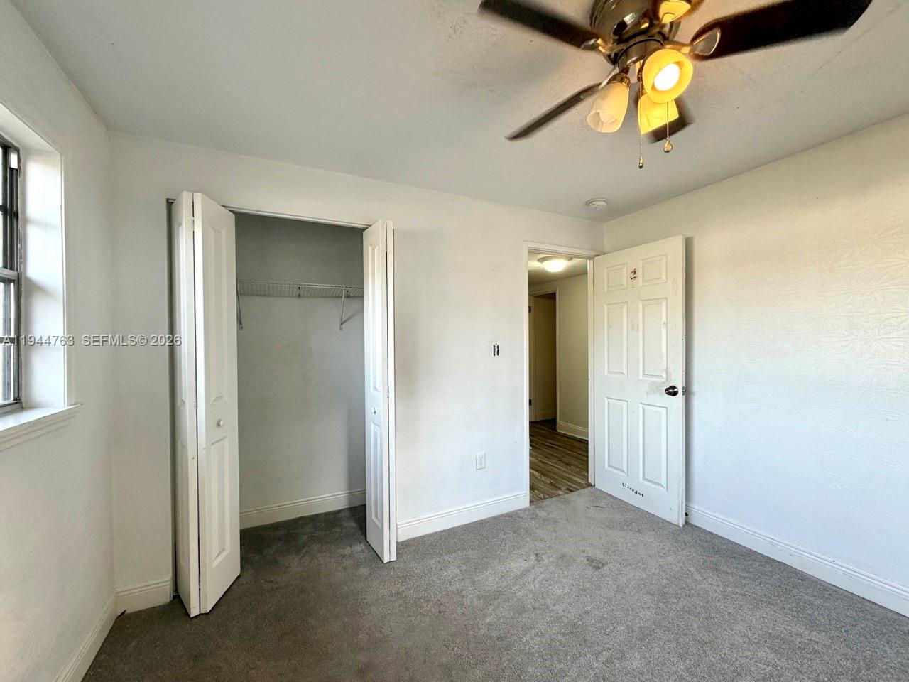 565 Forrest Drive Bartow, FL 33830 - Photo 16 of 44 an empty room with a chandelier fan and closet
