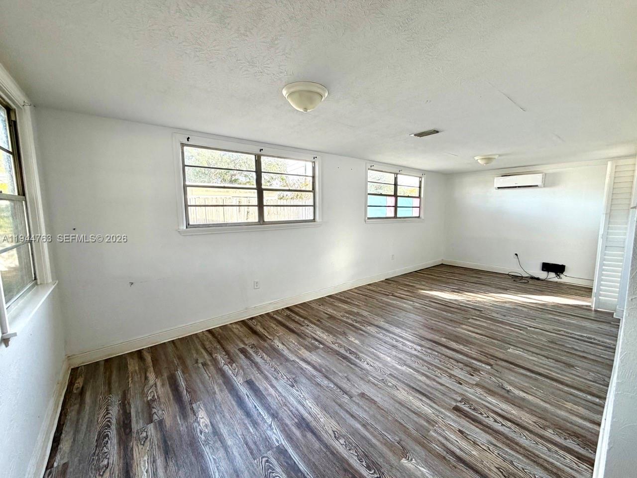 565 Forrest Drive Bartow, FL 33830 - Photo 2 of 44 an empty room with wooden floor and windows