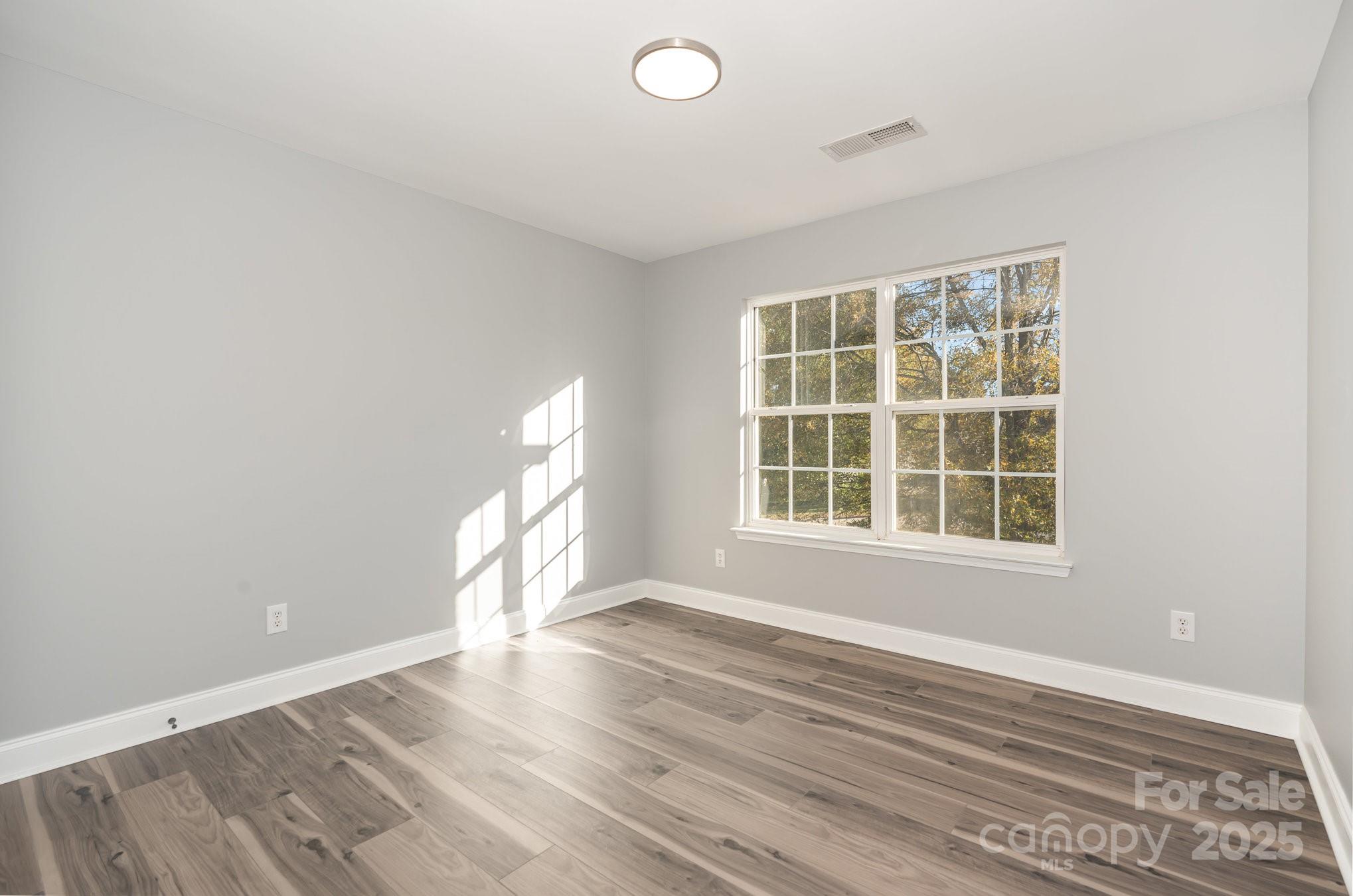 1457 Jc Raulston Court Hickory, NC 28602 - Photo 20 of 39 an empty room with wooden floor and windows