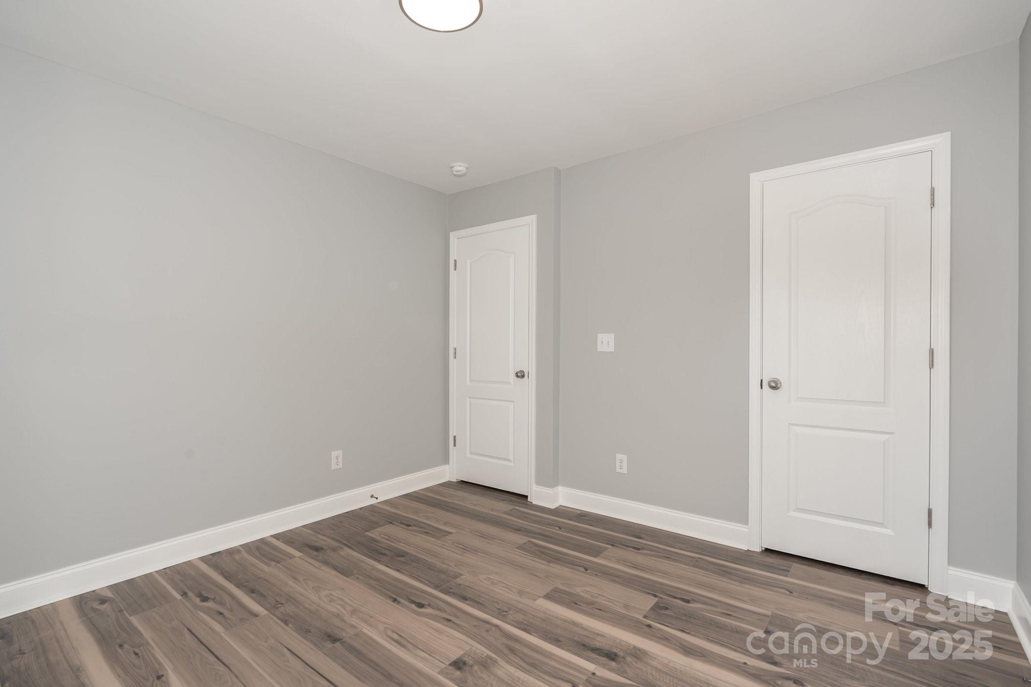 1457 Jc Raulston Court Hickory, NC 28602 - Photo 21 of 39 a view of an empty room with wooden floor and entryway
