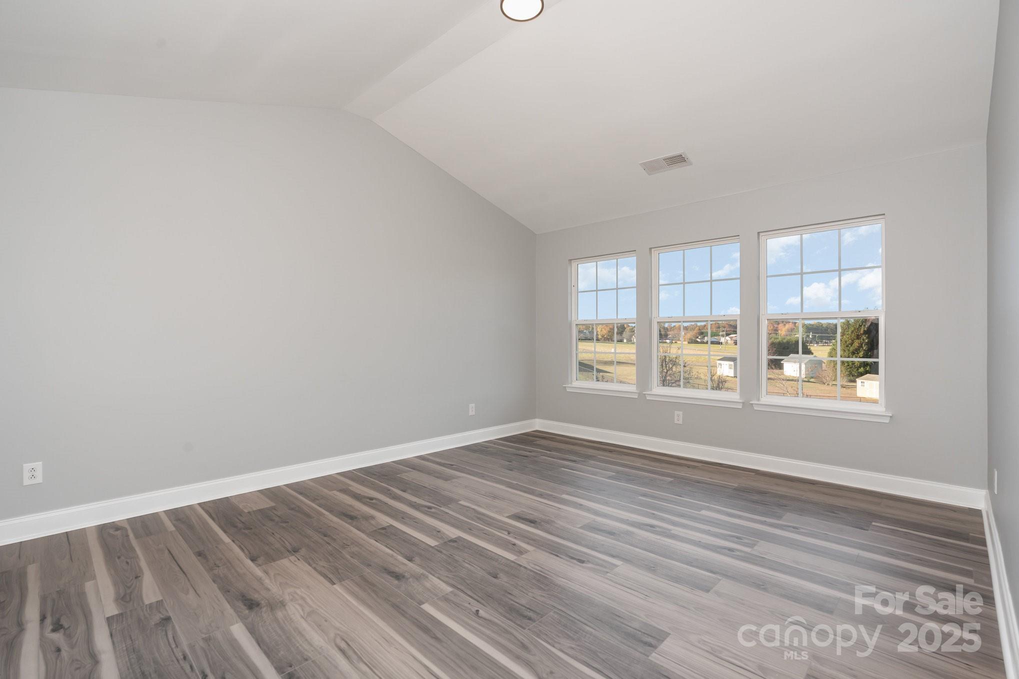1457 Jc Raulston Court Hickory, NC 28602 - Photo 27 of 39 wooden floor in an empty room with a window
