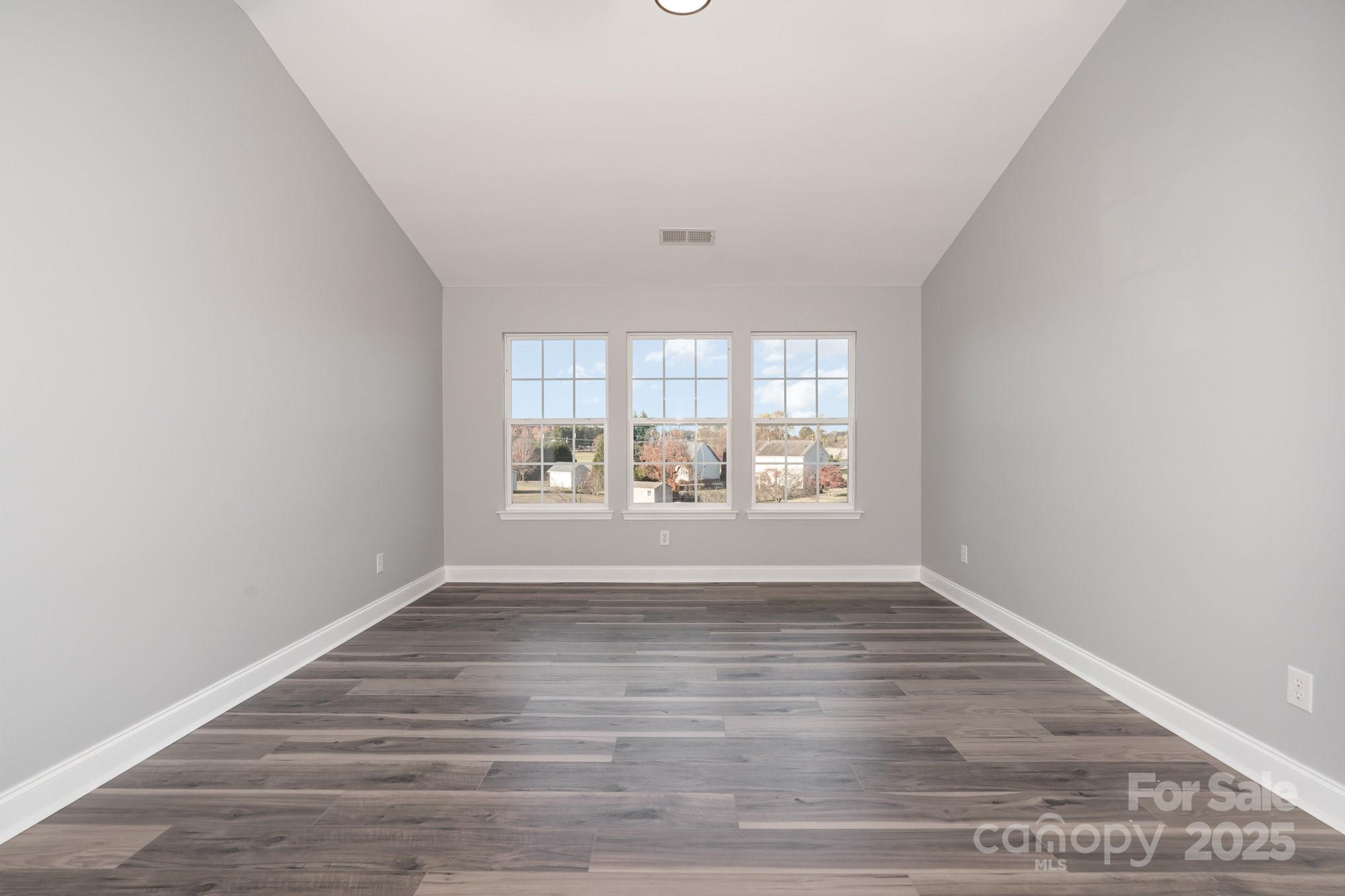 1457 Jc Raulston Court Hickory, NC 28602 - Photo 31 of 39 wooden floor in an empty room with a window