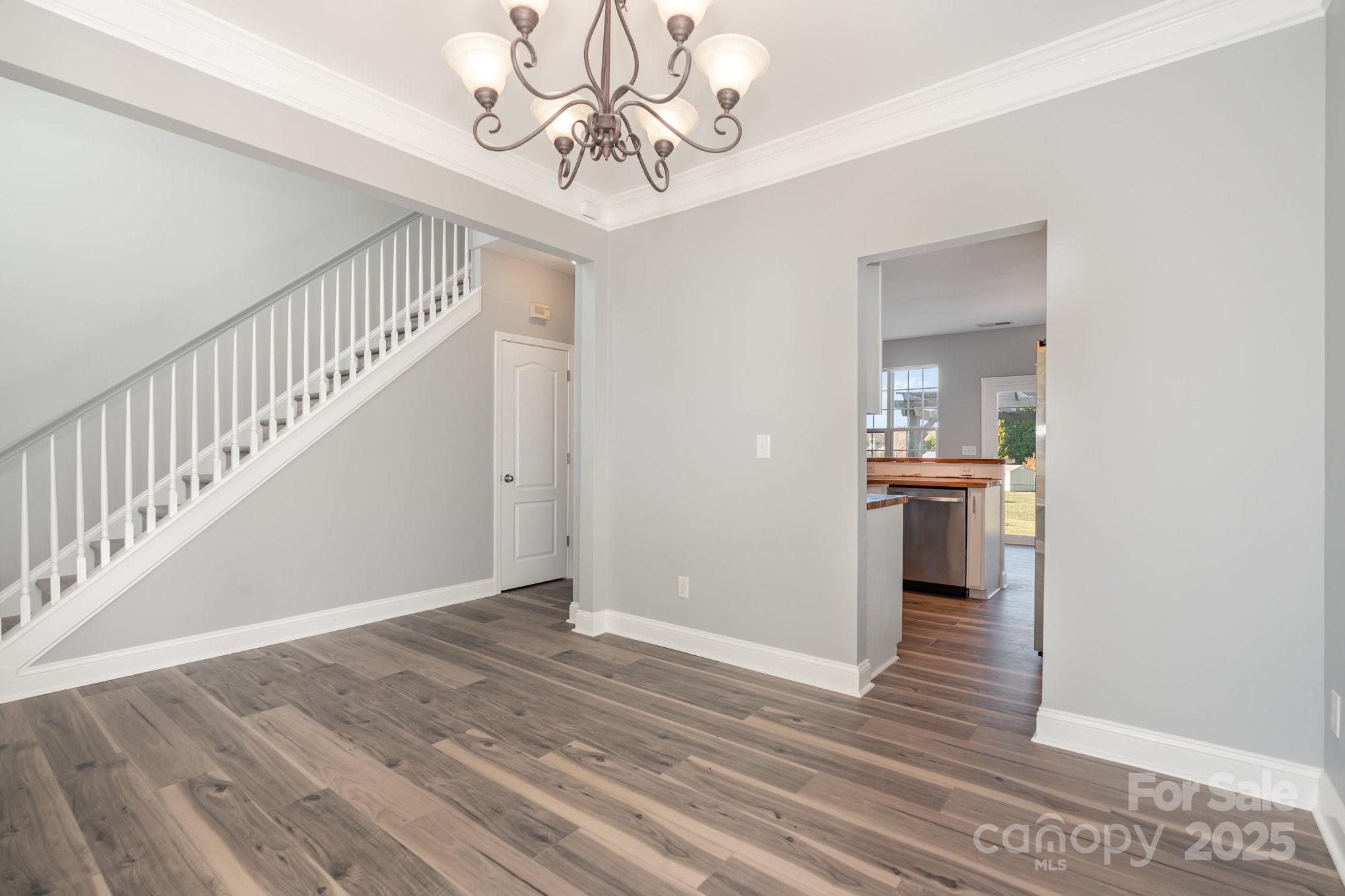1457 Jc Raulston Court Hickory, NC 28602 - Photo 5 of 39 a view of a hallway with wooden floor and a kitchen