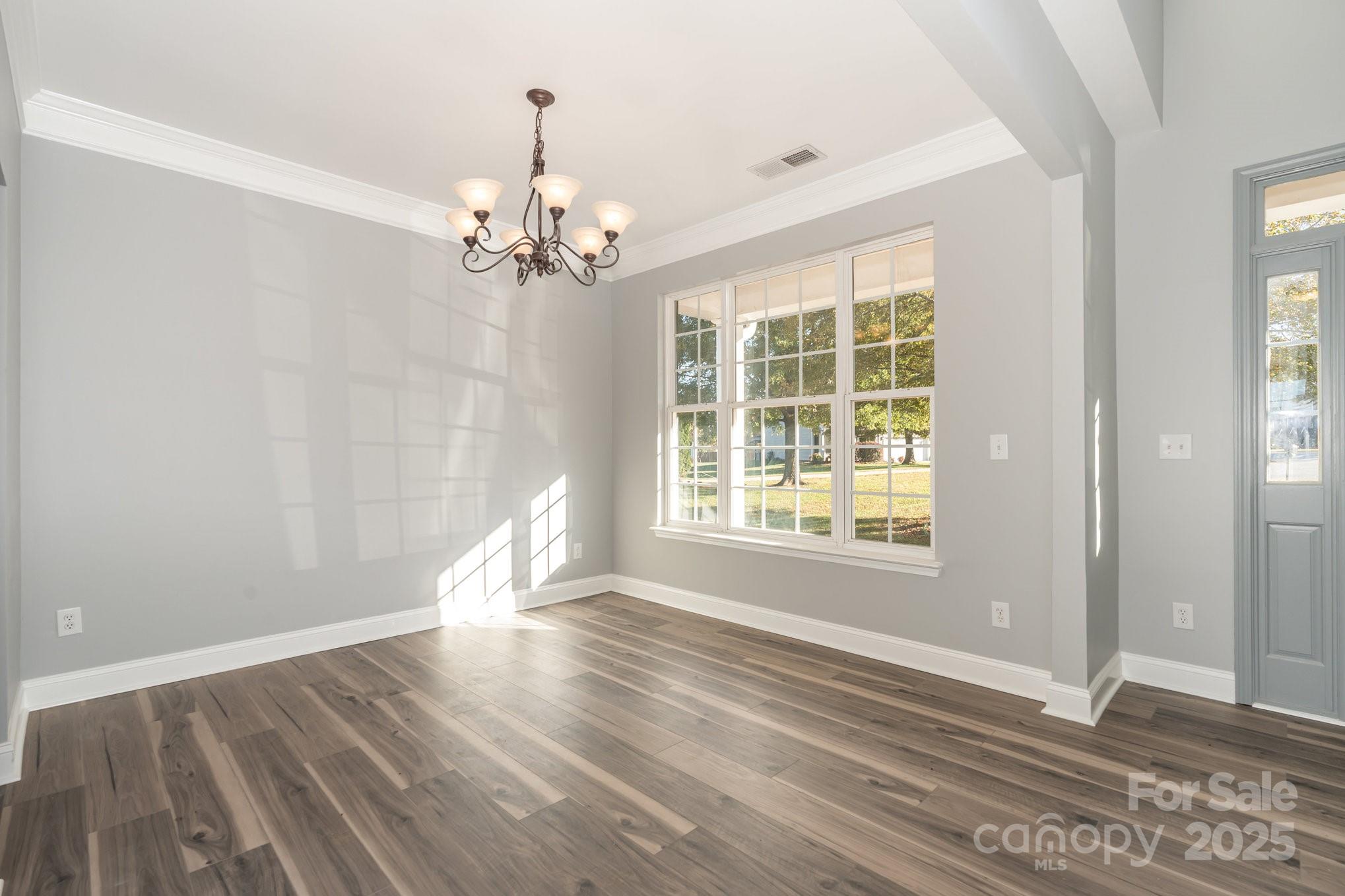 1457 Jc Raulston Court Hickory, NC 28602 - Photo 6 of 39 a view of empty room with wooden floor and fan
