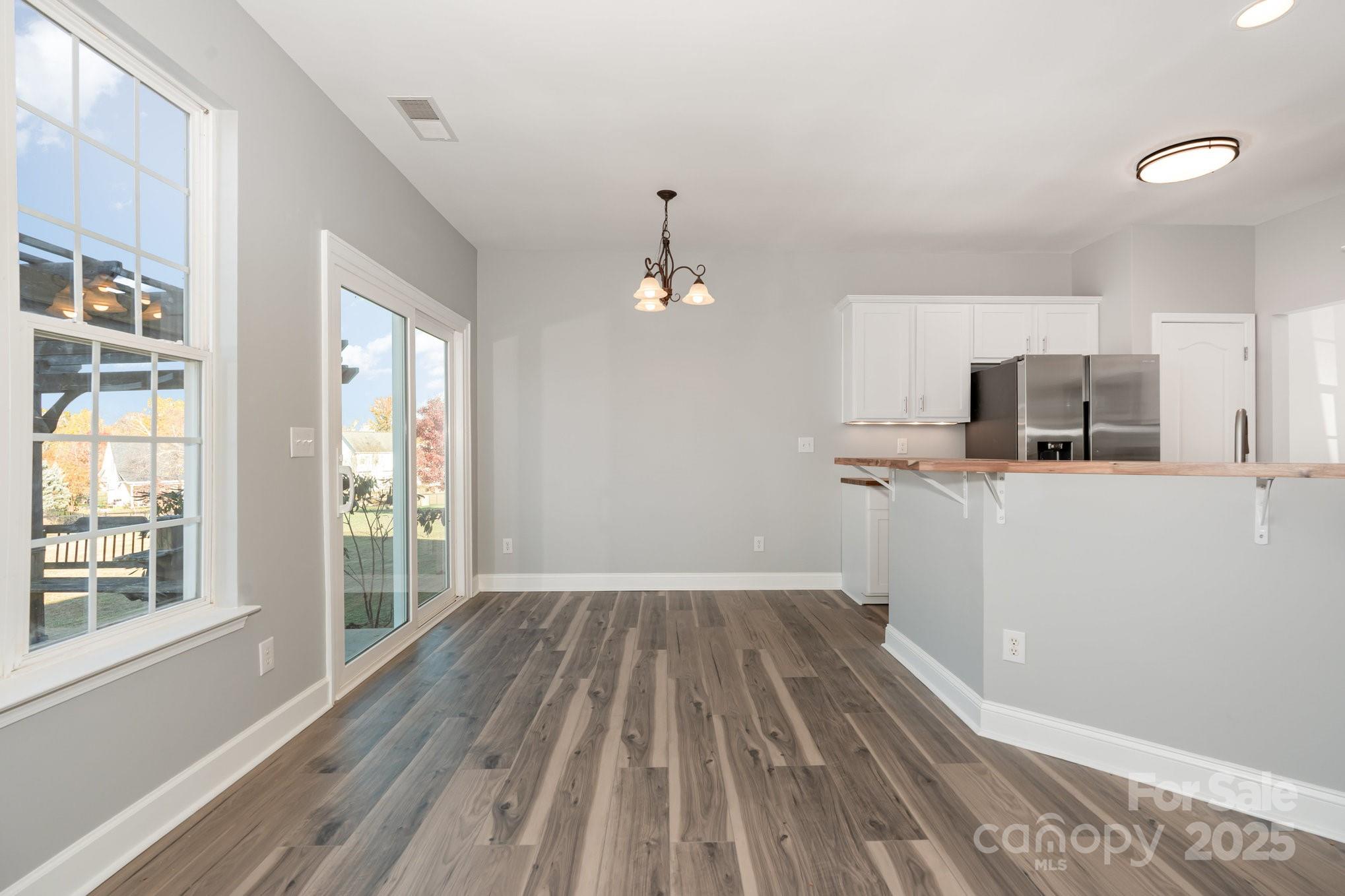 1457 Jc Raulston Court Hickory, NC 28602 - Photo 10 of 39 wooden floor in an empty room with a window