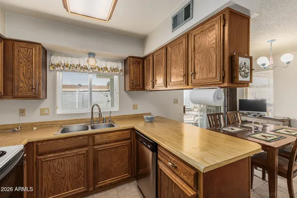 a kitchen with a sink a stove and cabinets