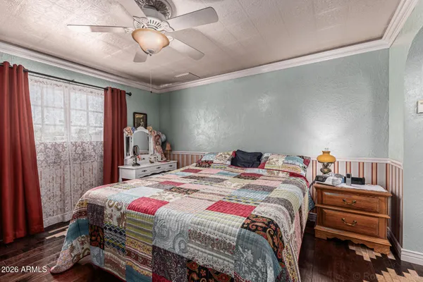 a bedroom with a bed and a chandelier