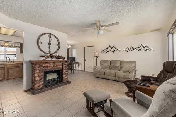 a living room with furniture a fireplace and a table