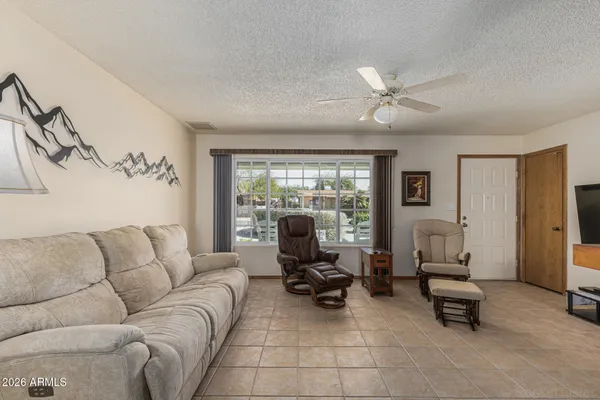 a living room with furniture and floor to ceiling window