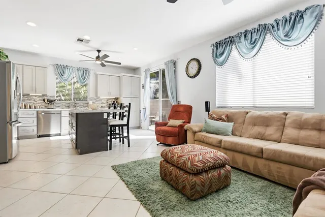 a living room with furniture and a large window