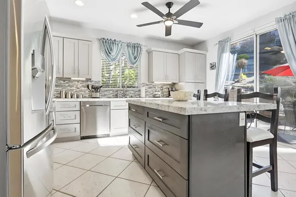 a kitchen with a sink cabinets and window