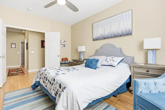 a bedroom with a bed and a lamp