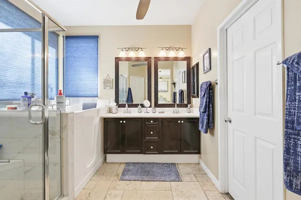 a bathroom with a double vanity sink and a mirror