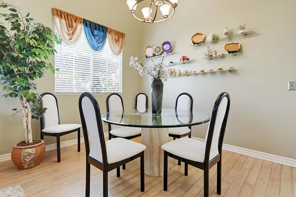 a view of a dining room with furniture and wooden floor