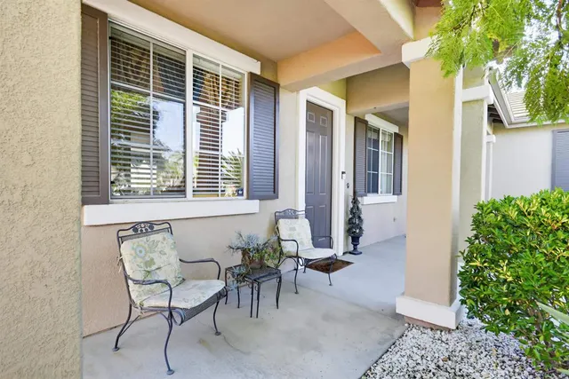 a view of an outdoor dining space with a table and chairs