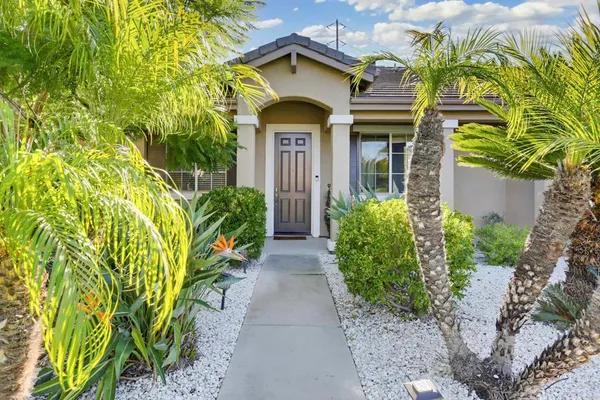 a front view of a house with a garden
