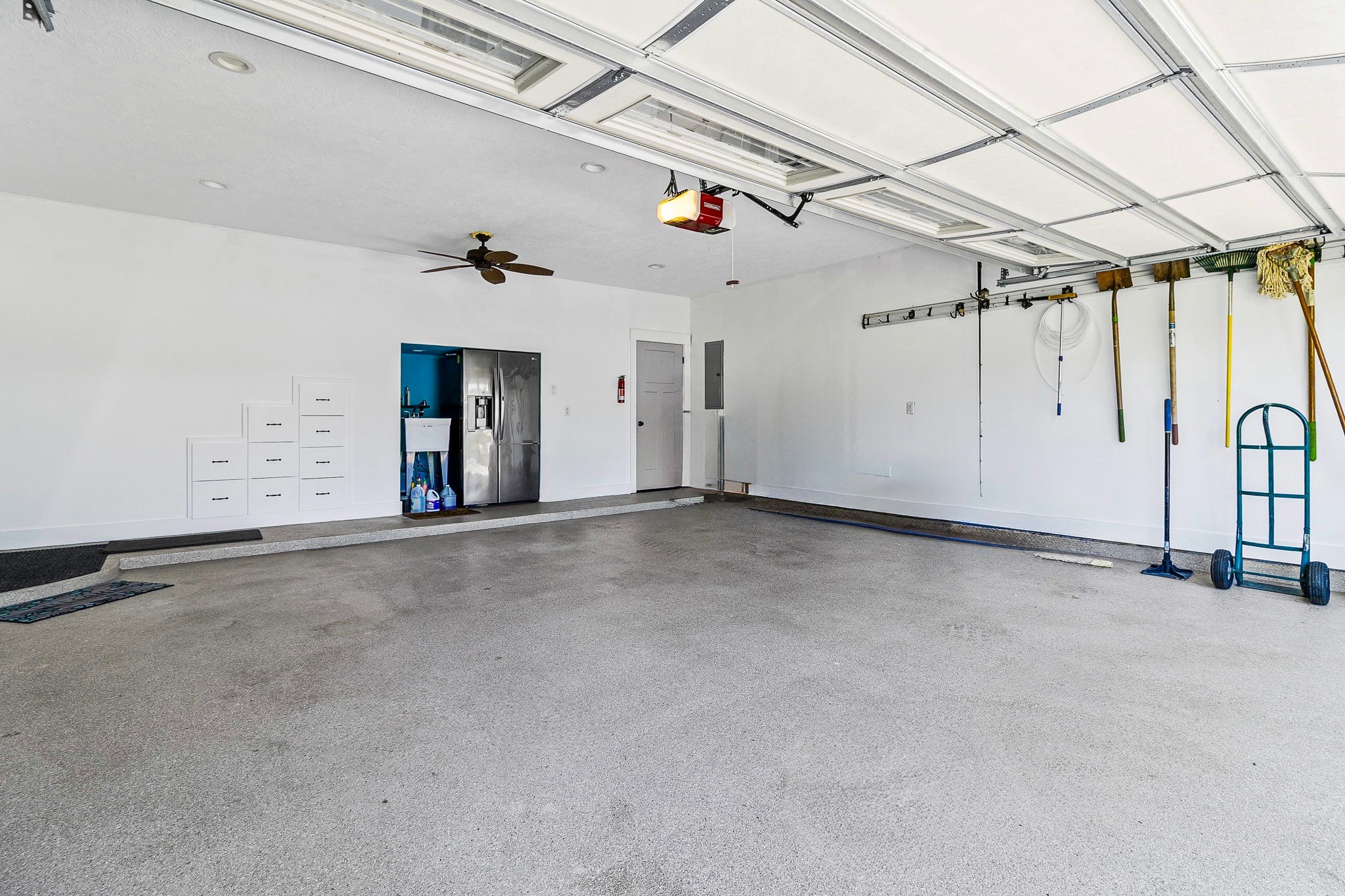 151 Key Largo Loop Point Blank, TX 77364 - Photo 35 of 49 Large, attached garage offers abundant space for vehicles, lake equipment, workshop needs, and extra storage.