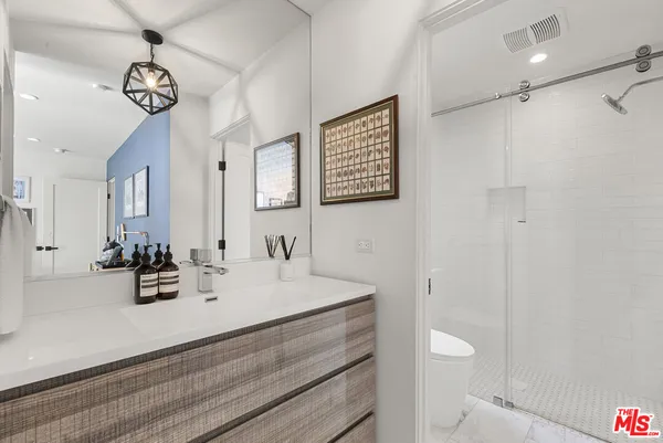 a bathroom with a sink a toilet and a mirror