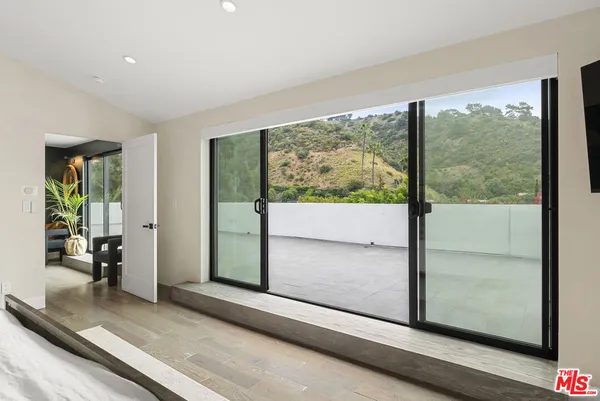 a view of a room with wooden floor and windows