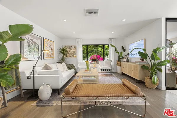 a living room with furniture flowerpot and a potted plant
