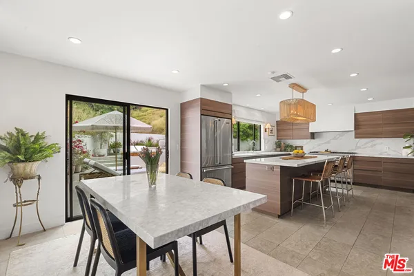 a kitchen with a table and chairs in it
