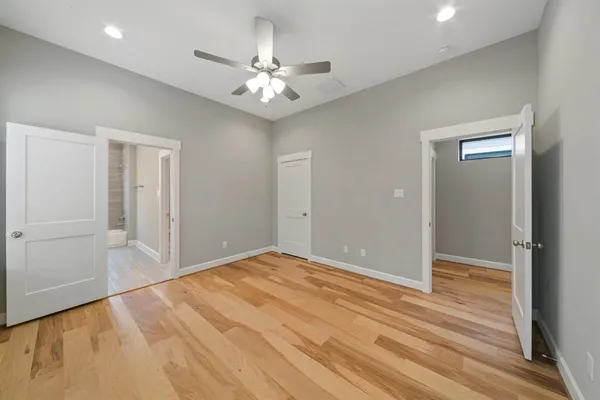 a view of an empty room with wooden floor
