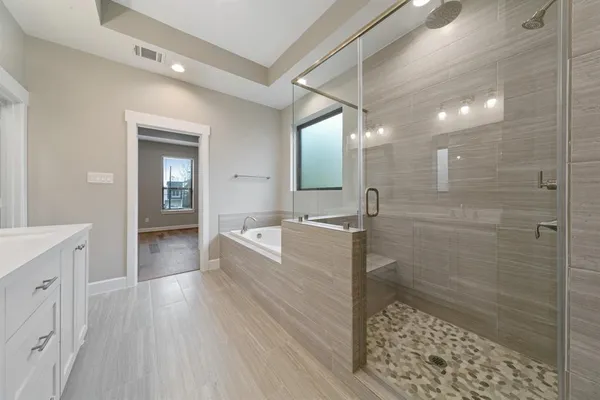 a large bathroom with a glass door shower sink and mirror