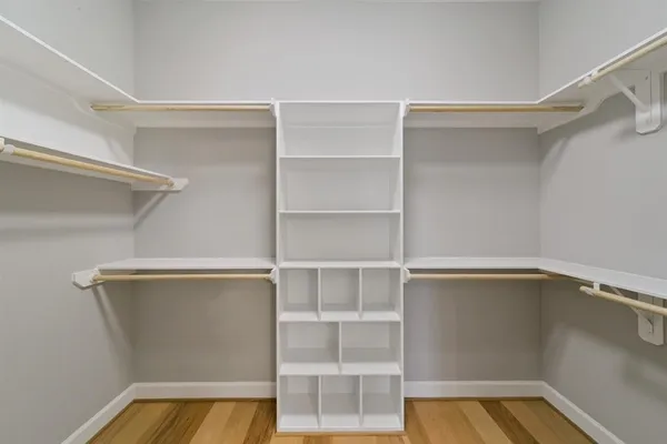 a view of walk in closet with empty racks
