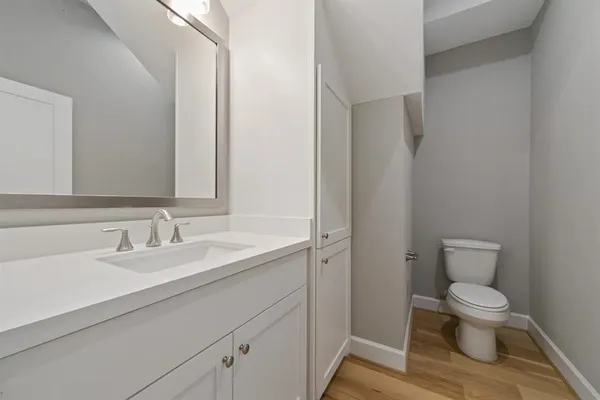 a white toilet sitting next to a bathroom sink
