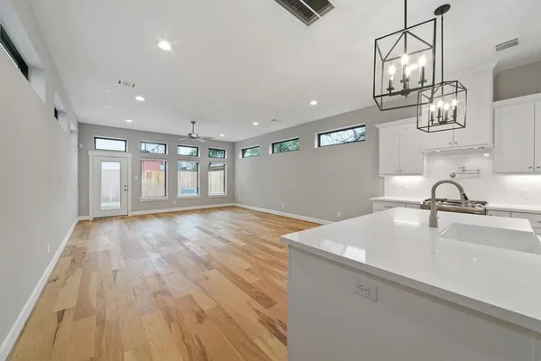 a view of a kitchen sink and wooden floor