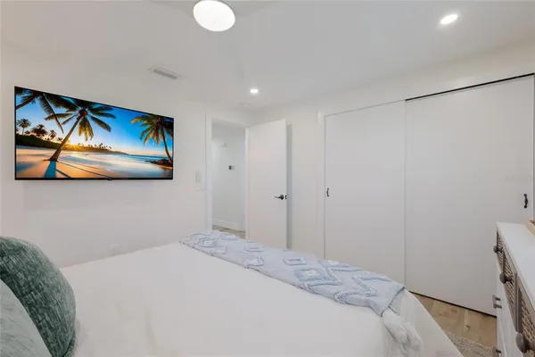 a bedroom with a bed and a painting on the wall