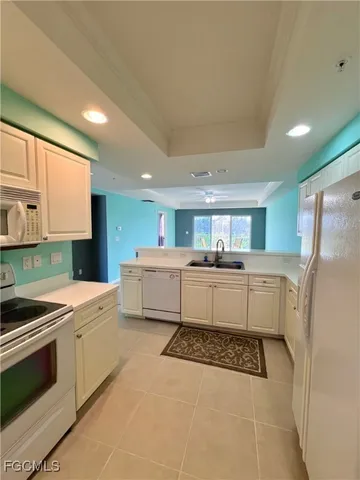a kitchen with a sink a stove top oven and cabinets