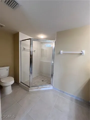 a bathroom with a shower and toilet