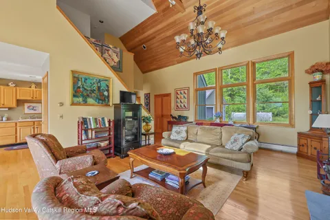 a living room with fireplace furniture and a chandelier