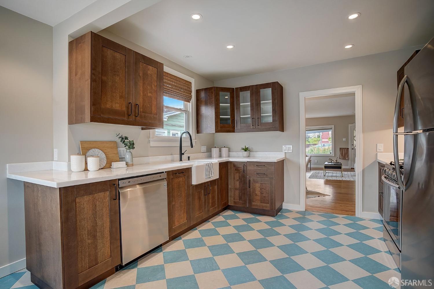 3014 Morcom Avenue Oakland, CA 94619 - Photo 12 of 36 a kitchen with a sink a stove a refrigerator and cabinets